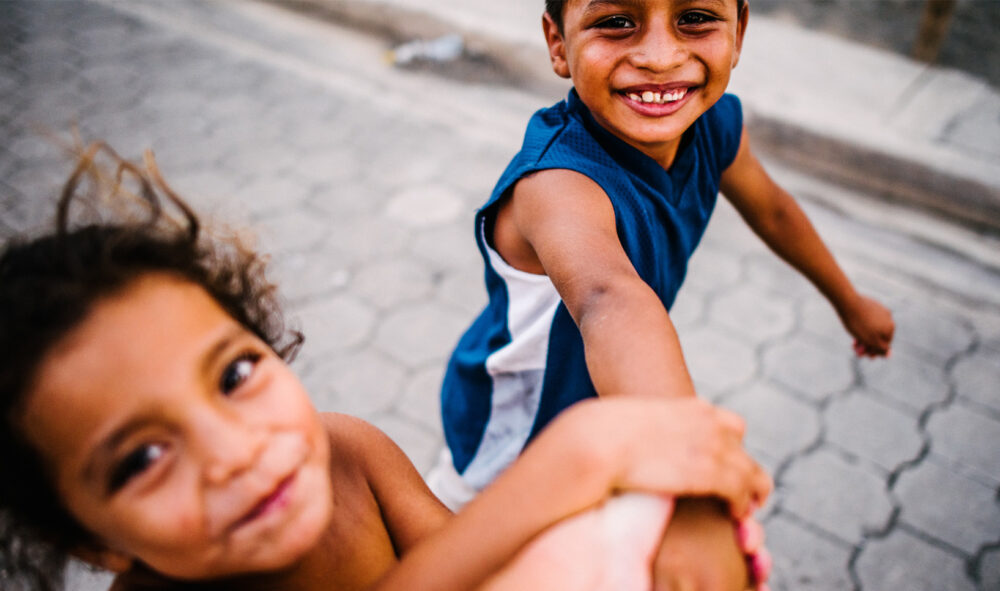 Two young Nicaraguan children playing in their community.